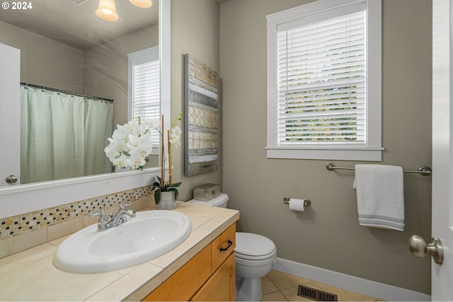 bathroom featuring vanity, toilet, and tile patterned floors