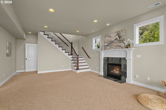 unfurnished living room featuring a fireplace and carpet floors