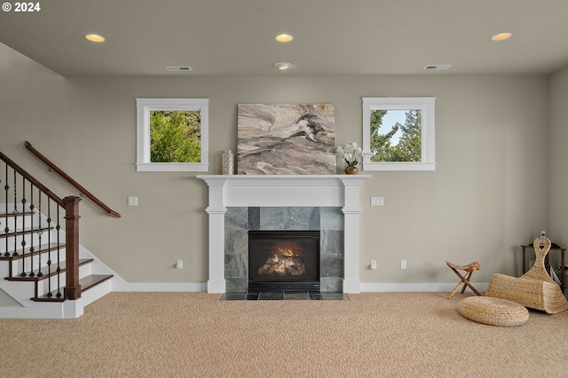 carpeted living room with a fireplace and a healthy amount of sunlight