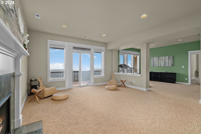 carpeted living room with a textured ceiling