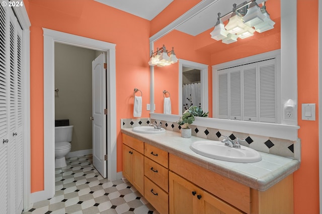 bathroom with toilet and vanity