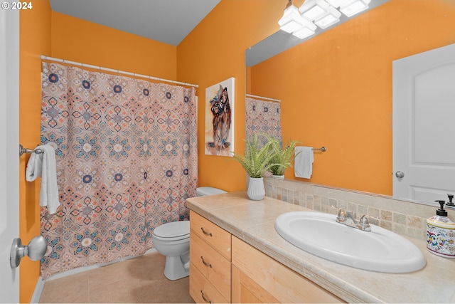 bathroom with vanity, toilet, tile patterned floors, and walk in shower