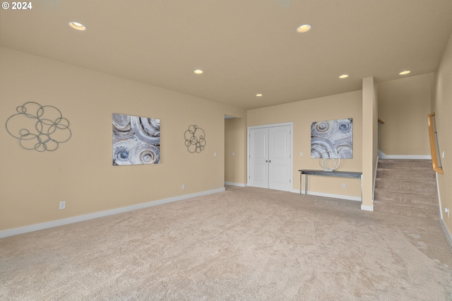 unfurnished living room featuring light carpet