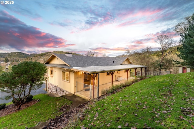 property exterior at dusk with a yard