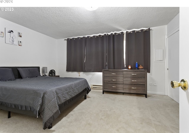 carpeted bedroom featuring a textured ceiling and a baseboard radiator