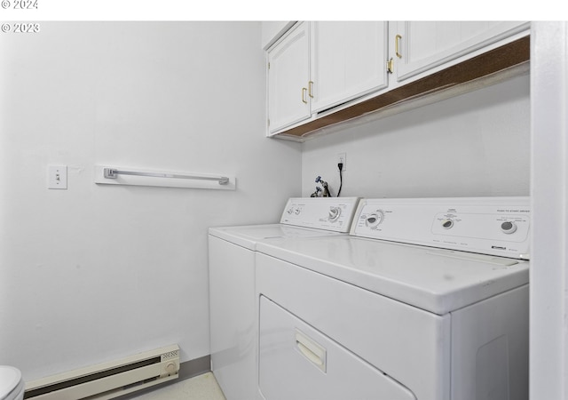 washroom with washer and clothes dryer and a baseboard heating unit