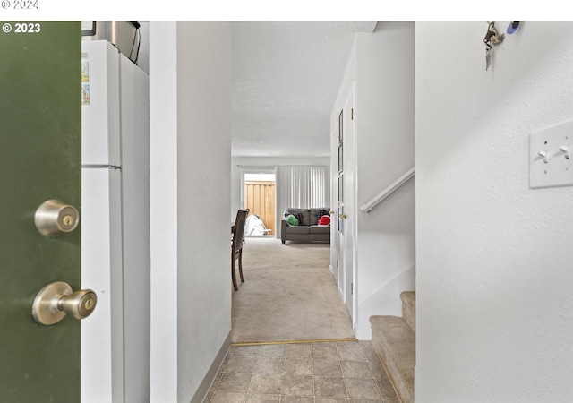 hallway featuring light colored carpet