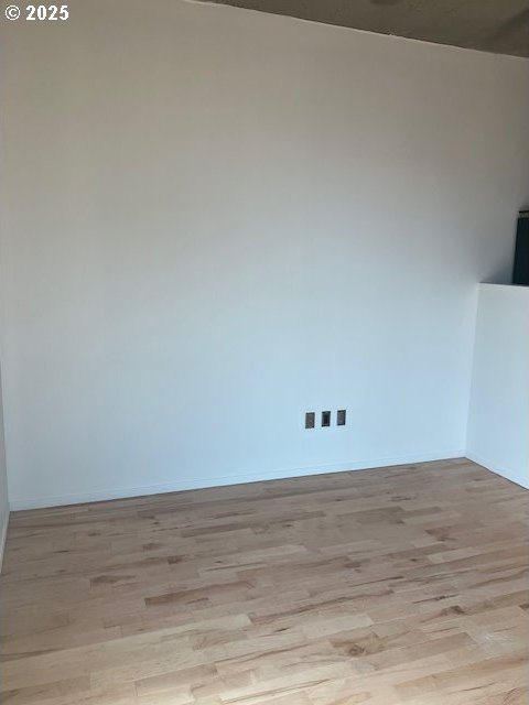 1410 SW 11th Ave Unit 402, Portland, OR 97201 - empty room featuring light wood finished floors and baseboards