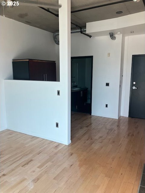 1410 SW 11th Ave Unit 402, Portland, OR 97201 - unfurnished room with light wood-style floors and a sink