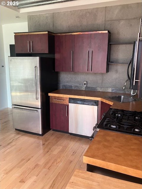 1410 SW 11th Ave Unit 402, Portland, OR 97201 - kitchen featuring appliances with stainless steel finishes and light wood-type flooring