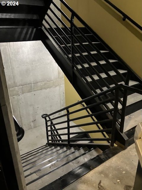 staircase featuring concrete floors