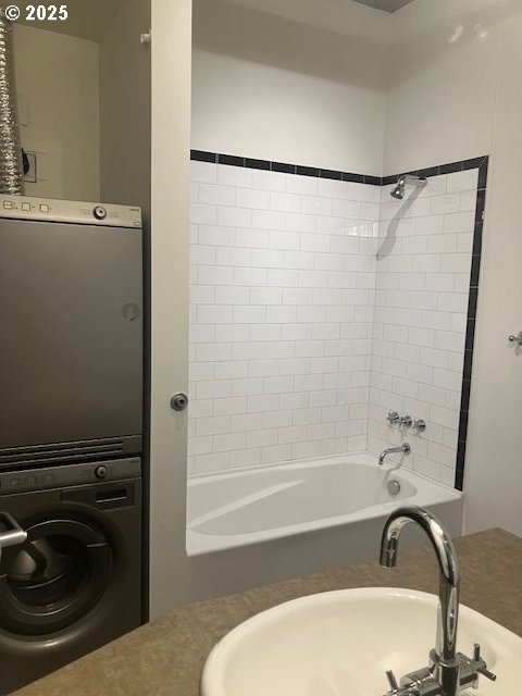 1410 SW 11th Ave Unit 402, Portland, OR 97201 - full bath featuring stacked washer / drying machine and tub / shower combination