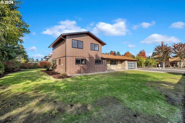 rear view of property featuring a lawn