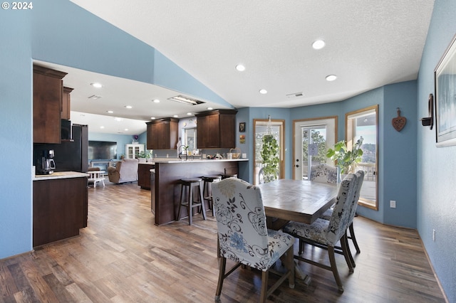 dining area with dark hardwood / wood-style flooring and a textured ceiling