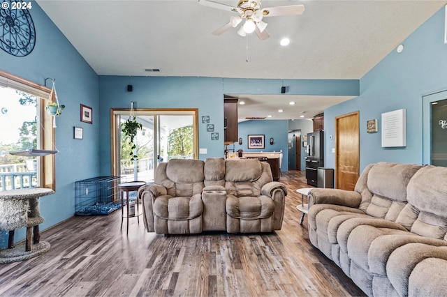 living room featuring hardwood / wood-style flooring, a wealth of natural light, and ceiling fan