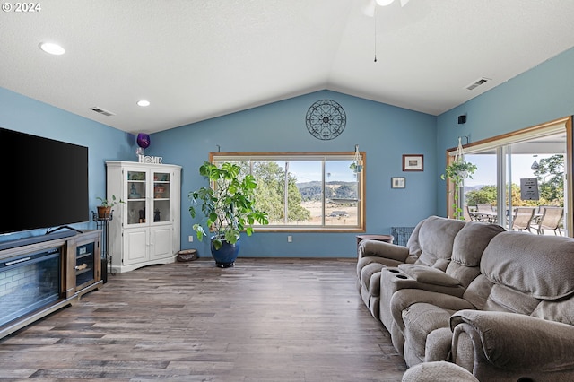 living room featuring hardwood / wood-style floors and vaulted ceiling