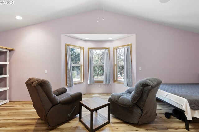 bedroom featuring light hardwood / wood-style floors and vaulted ceiling