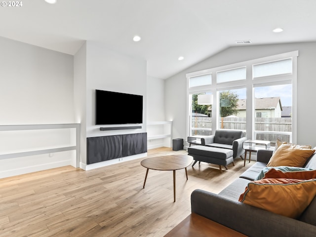 living room with vaulted ceiling and light hardwood / wood-style flooring