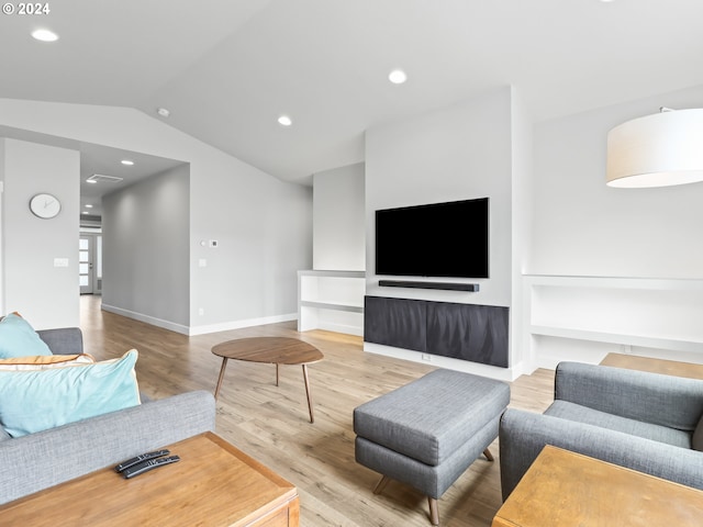 living room featuring vaulted ceiling and hardwood / wood-style floors