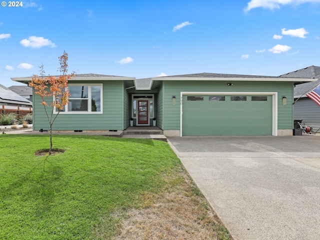 view of front facade with a front yard and a garage