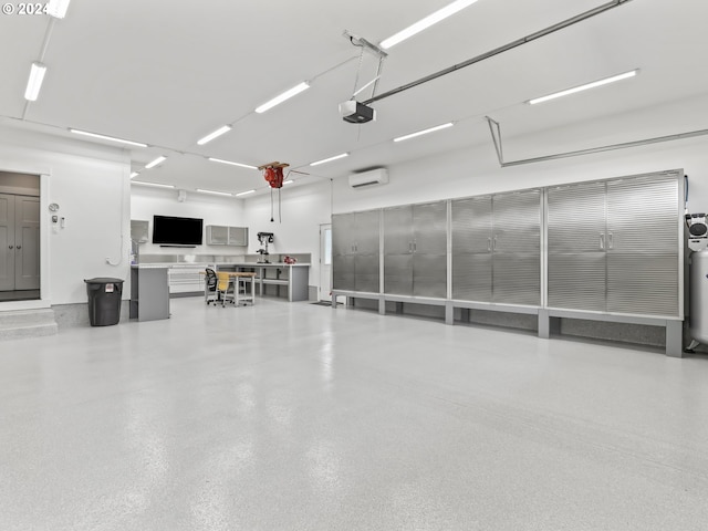 garage with a garage door opener and a wall mounted AC