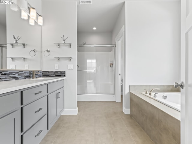 bathroom with vanity, separate shower and tub, tile patterned flooring, and backsplash