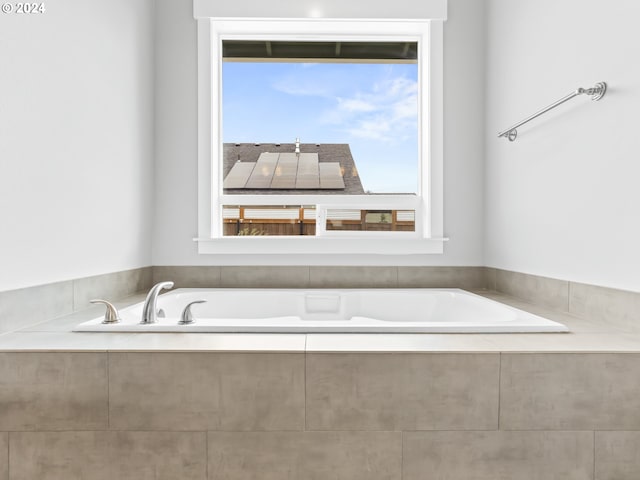 bathroom with a relaxing tiled tub