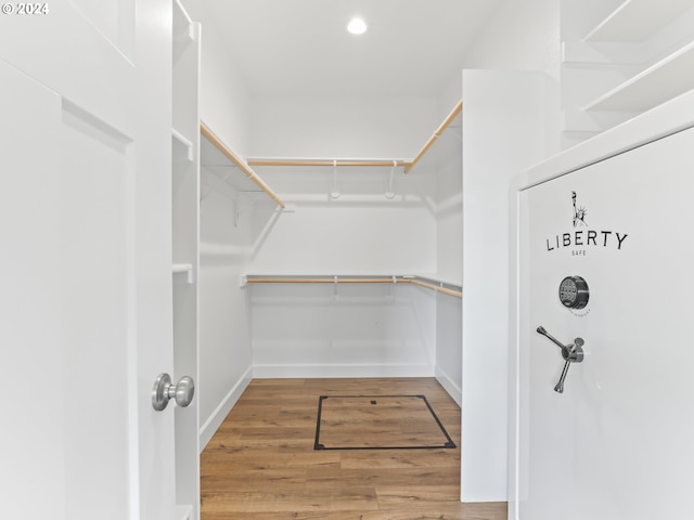 spacious closet with hardwood / wood-style flooring