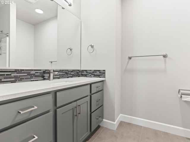 bathroom featuring tasteful backsplash, vanity, and tile patterned floors