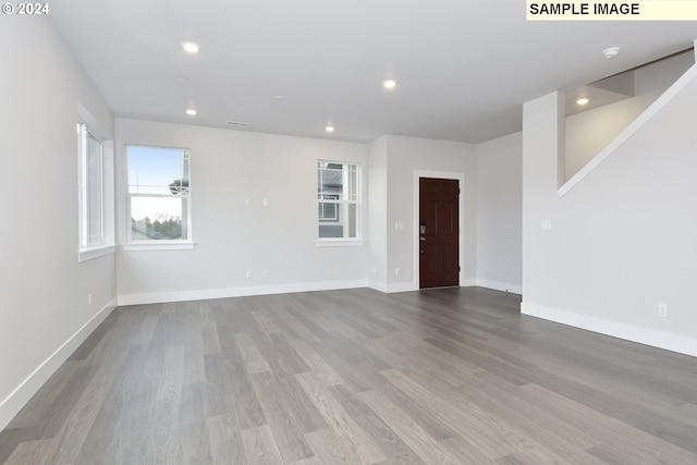 spare room with light hardwood / wood-style flooring