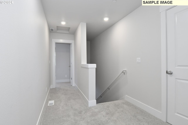 corridor with light colored carpet