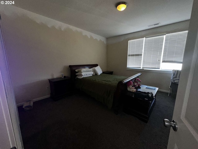 bedroom featuring dark carpet