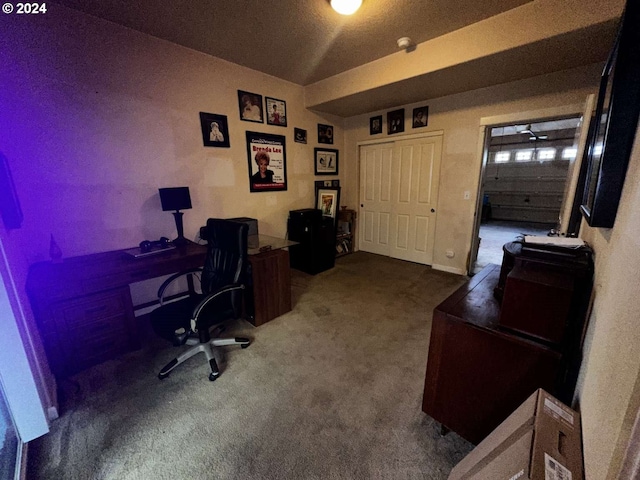 carpeted home office with a textured ceiling