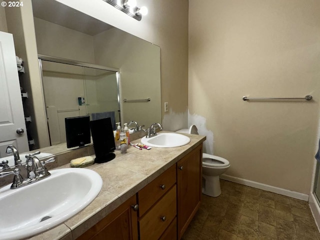 bathroom featuring vanity, an enclosed shower, and toilet