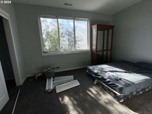 bedroom featuring dark colored carpet