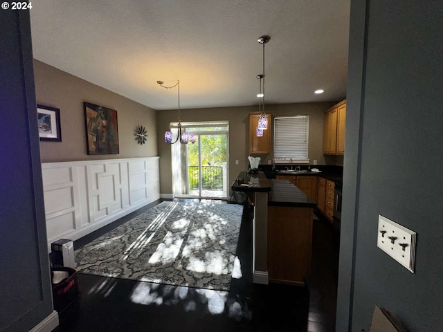 kitchen featuring sink, hanging light fixtures, and a chandelier