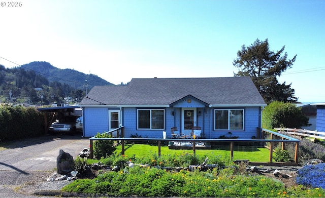94142 4th St, Gold Beach, OR 97444 - view of front of property with a mountain view, roof with shingles, an attached carport, and driveway
