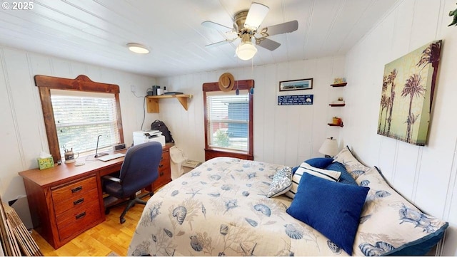 94142 4th St, Gold Beach, OR 97444 - bedroom featuring multiple windows, light wood finished floors, a desk, and ceiling fan