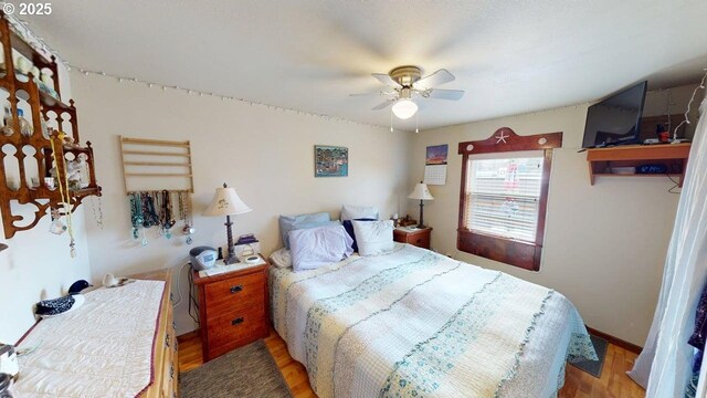 94142 4th St, Gold Beach, OR 97444 - bedroom featuring wood finished floors and ceiling fan