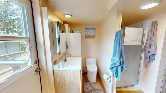 94142 4th St, Gold Beach, OR 97444 - full bathroom with toilet, vanity, a shower stall, and wood finished floors