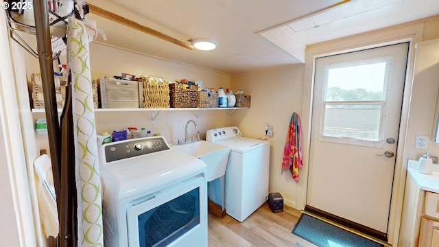 94142 4th St, Gold Beach, OR 97444 - washroom with light wood-style flooring and washing machine and dryer