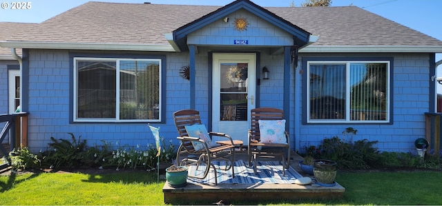 94142 4th St, Gold Beach, OR 97444 - doorway to property with a shingled roof, a lawn, and a patio area