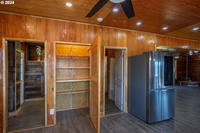 kitchen with dark wood-style floors, smart refrigerator, wood ceiling, ceiling fan, and wooden walls