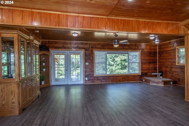 unfurnished living room with ceiling fan, wooden ceiling, dark hardwood / wood-style flooring, and french doors