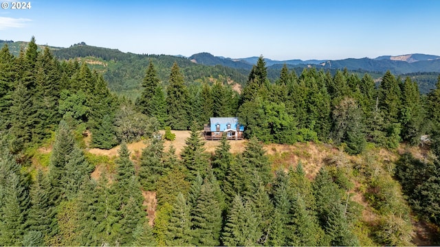 drone / aerial view with a mountain view and a view of trees