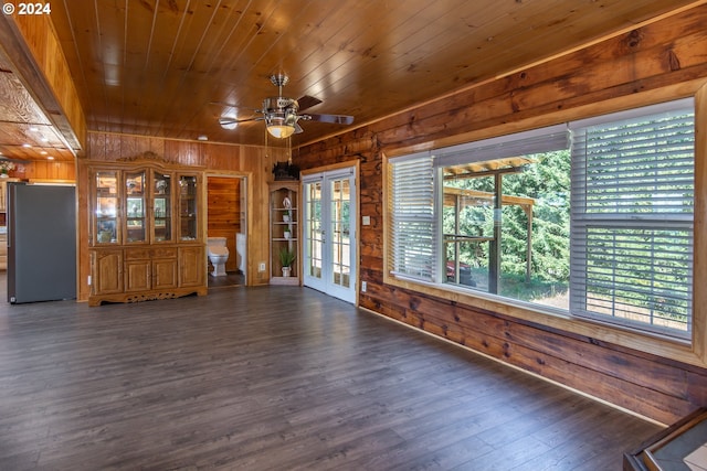 interior space with dark wood-style flooring, french doors, wood walls, and wood ceiling