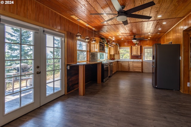 kitchen with wood ceiling, light countertops, hanging light fixtures, and freestanding refrigerator