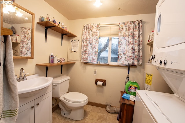 bathroom with toilet, stacked washer and clothes dryer, and vanity