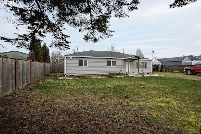 back of house featuring a yard