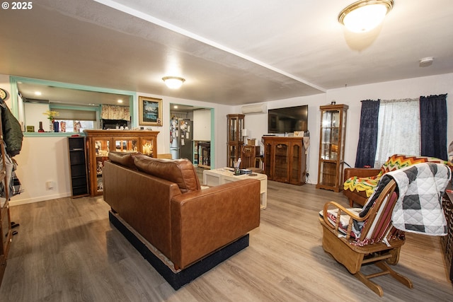 living room featuring a wall unit AC and hardwood / wood-style flooring